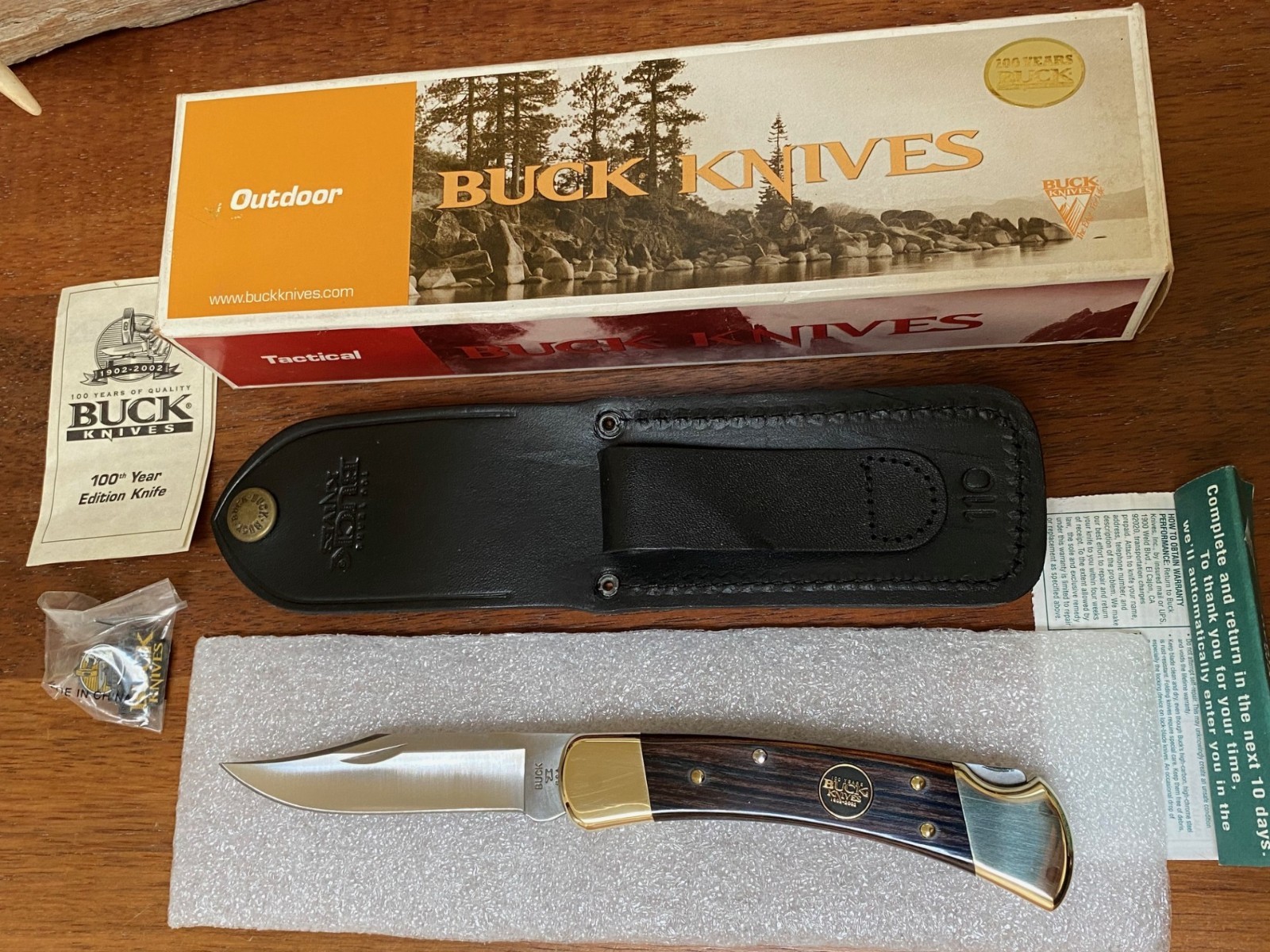 Buck Knife 110 – (2002) 100th Anniversary W/ Pin, Box, Sheath, and Papers *NOS*